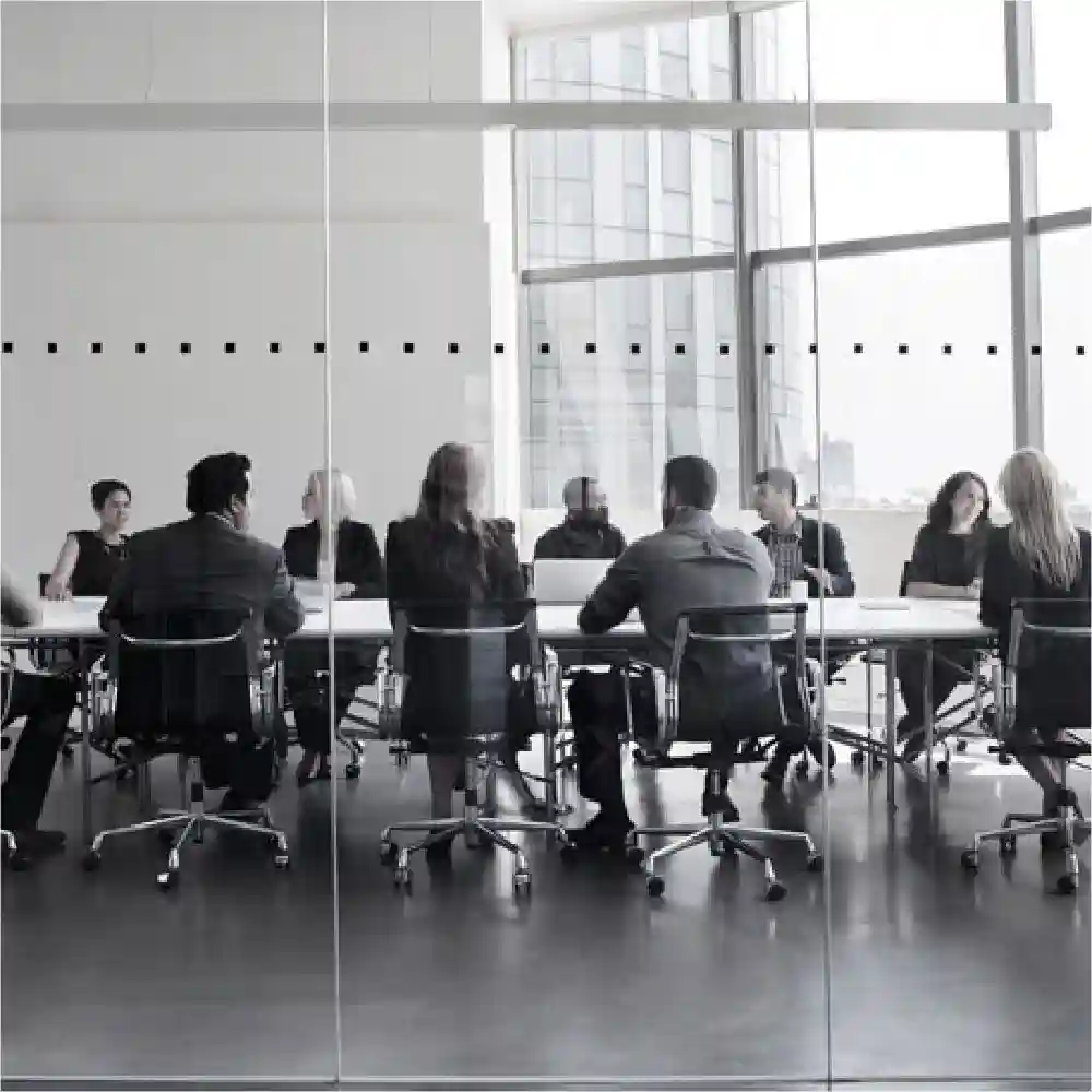People sitting in a conference room talking.