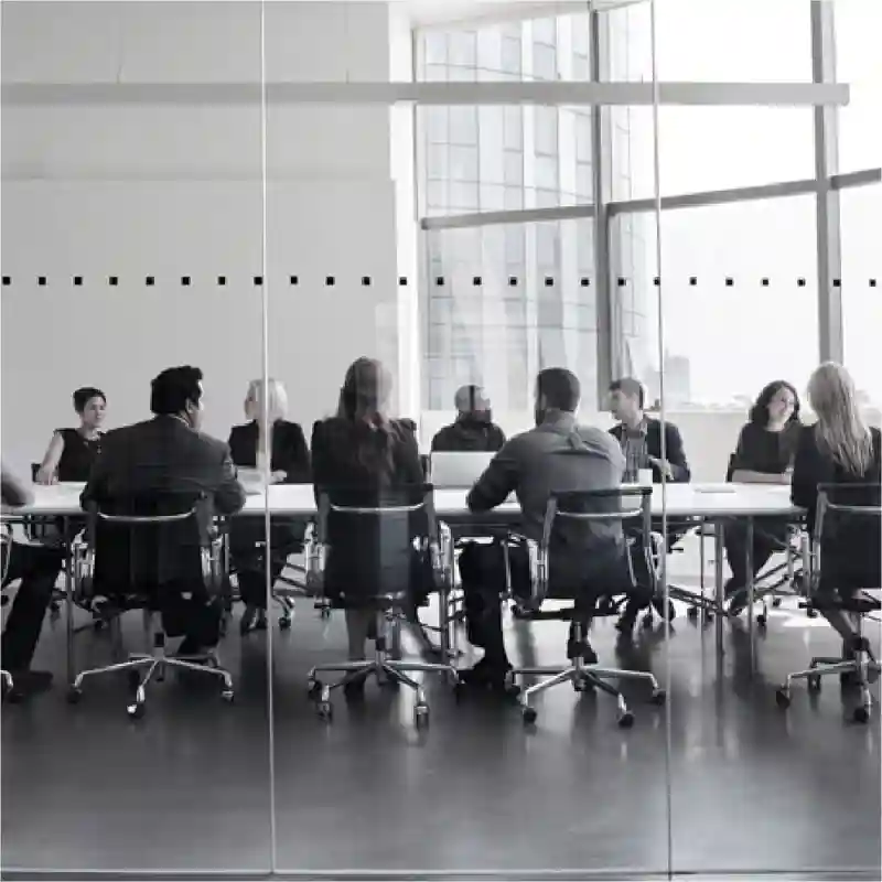 People sitting in a conference room talking.