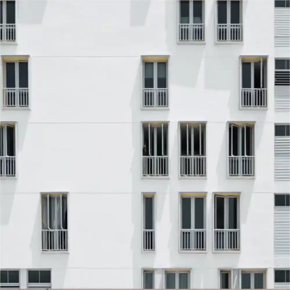 Open windows on the side of a white building.