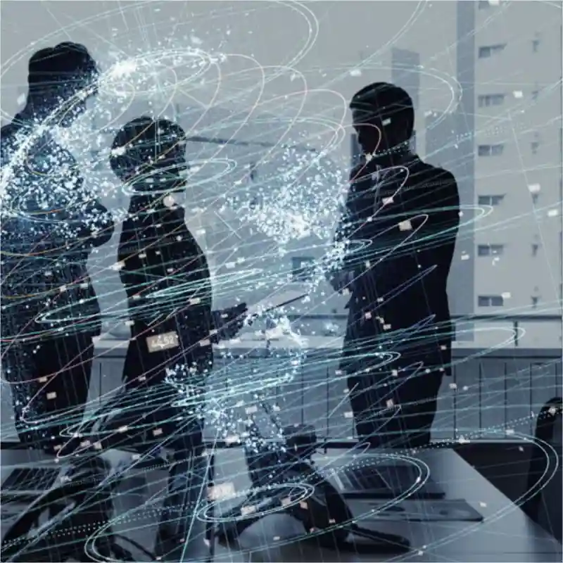 Three people talking in a conference room.